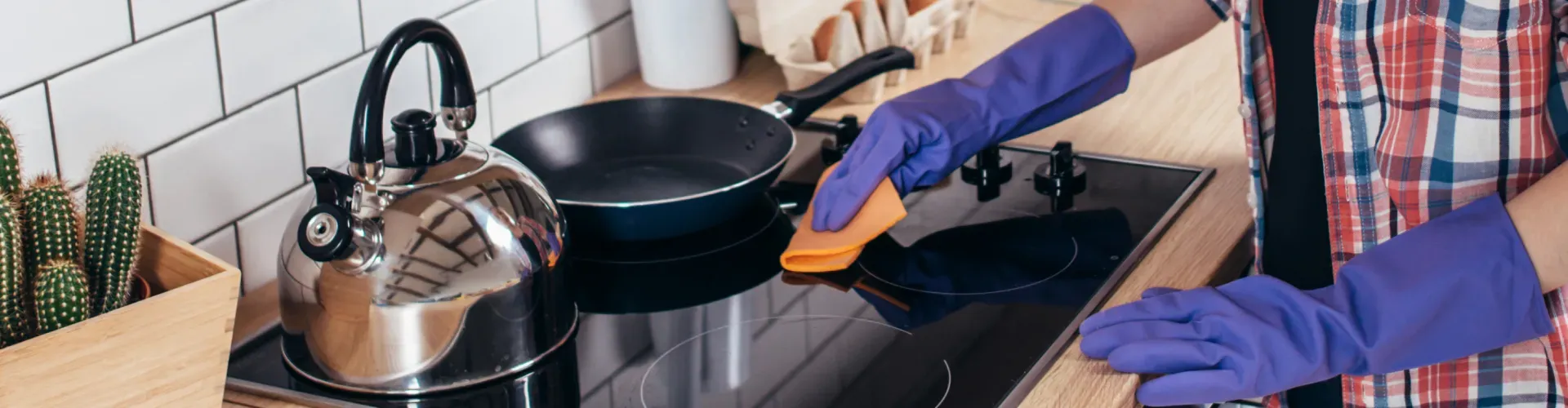 woman-cleaning-cooktop